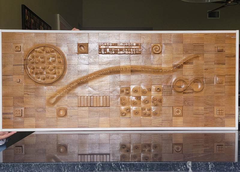 Carved panel in teak wood.